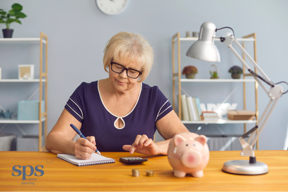 Senior lady calculating expenses with a piggy bank and calculator, illustrating financial planning support from Senior Planning Services.