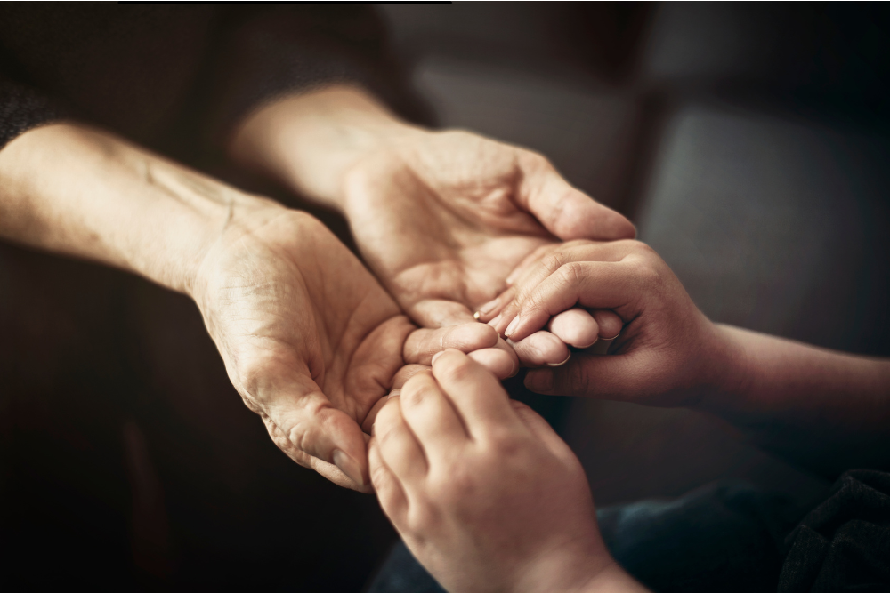 An old person's hands with his guardian or power of attorney's hands