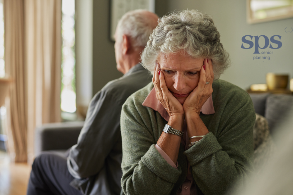 Woman looking distressed while reviewing Medicaid eligibility paperwork, with Senior Planning Services ready to help her find solutions and ease her worries.